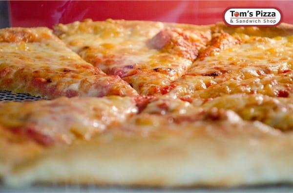 Serving fresh oven hot slices all day long at Tom's since 1964