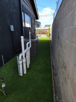 Artificial turf around pool equipment.