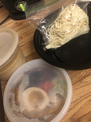 Uncooked noodles, toppings, and broth all packaged separately