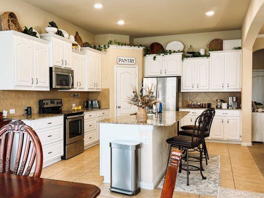 AFTER (kitchen has a brighter, lighter, and airier feel- and the refacing surfaces are water resistant, with a very durable feel to them)