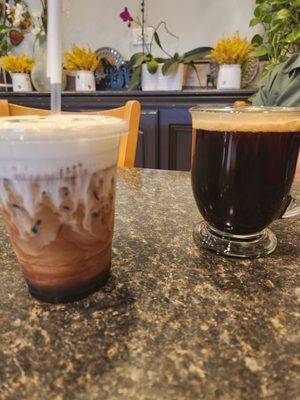 Americano coffee on the right and iced cafe Freddo with cookie dough flavor on left