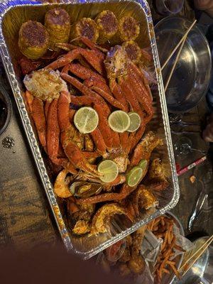 Family seafood combo plate! Lobster tail, crab legs, shrimp, crawfish, muscles, corn and potato.