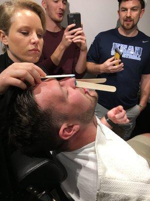 The anxious groom is getting ready for his big night with a nose wax.