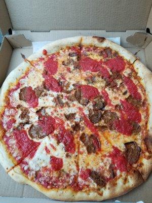 Meatball pizza with extra sauce.