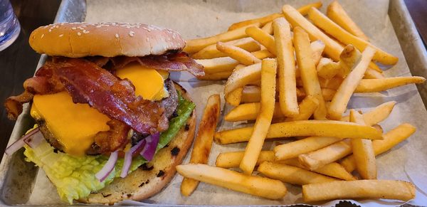 Classic Burger w/ cheddar, bacon, lettuce, tomato, & red onion, w/ fries.