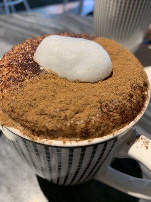 Latte with cinnamon and cocoa dusting.