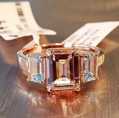 A 3.20 ct emerald cut Morganite nestled between 2 Santa Maria, emerald cut aquamarines, totaling 0.95