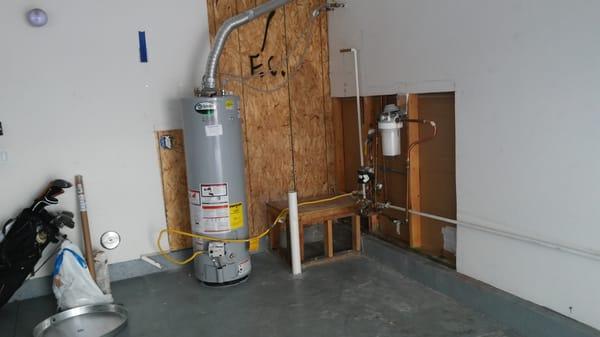 Water heater sprung a leak and flooded garage. Here we just replaced the water heater and started repairing the dry wall.