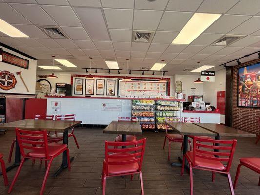 Empty counter. All five (5) staff in back eating chips and food.