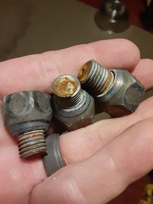 The 3 lug bolts and nuts that snapped off due to being overtorqued after a brake job.