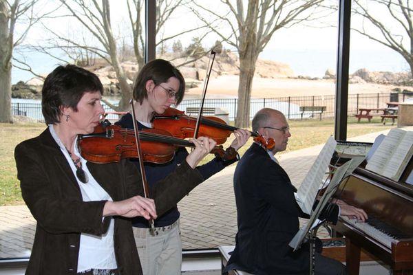 Musicians play in the Connecticut Hospice lobby with water views