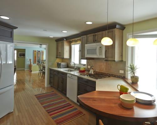 Transitional kitchen design with two tone cabinets, solid wood eating counter