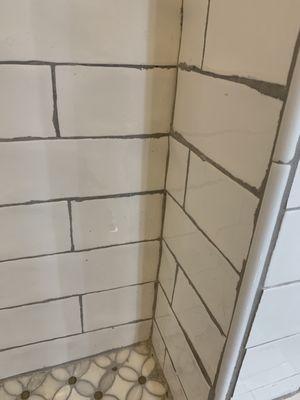 sloppy grouting, grout stuck all over tile