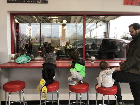 My kids watching them replace our tire