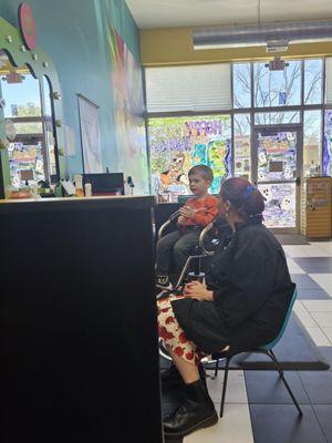 Christina sitting with my son so I could get a haircut.