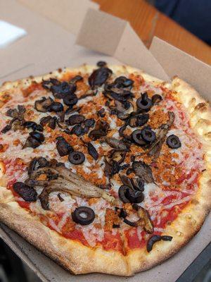 Vegan pizza with sausage, mushrooms, black olives