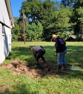 Digging to find the pipe going into the sewer tanks.