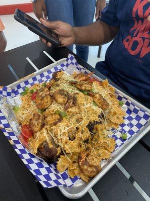 Turkey covered in shrimp with Cajun pasta.