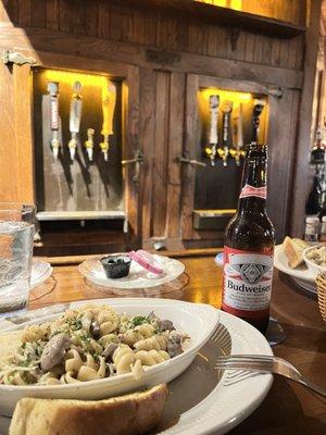 Stroganoff and Budweiser in front of the classic icebox taps