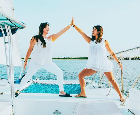 Teachers Molly and Val making shapes on Cohort 5's graduation sail!