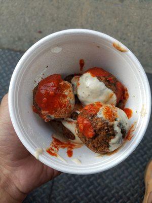 Falafel balls with hot sauce and tahini