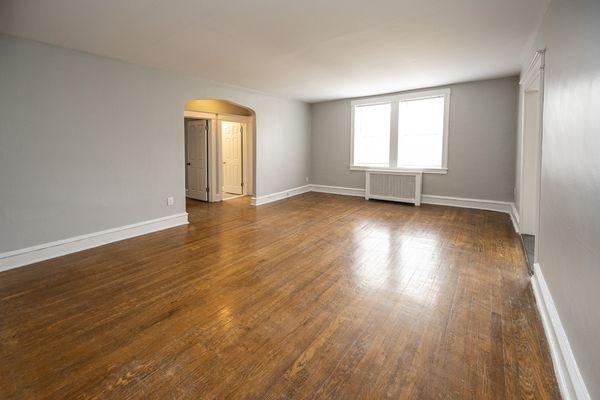 Upsal's spacious living room with wood floors