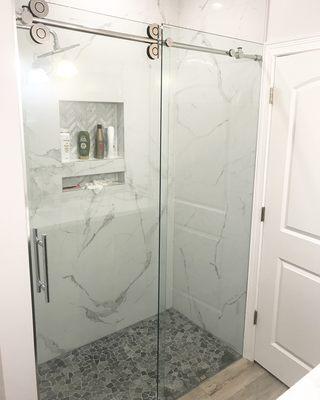 Barn door frameless shower enclosure