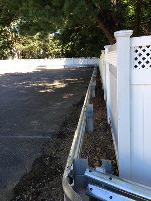 Pvc fence with guard rail in a parking lot