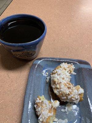 Pour over black coffee with a coconut donut