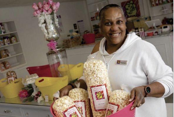 8/17/22 New business owner Robbin Jackson displays some of her products in Nutmeg Kettlecorn.  Photo courtesy Record-Journal