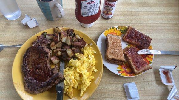 Steak, scrambled eggs and home fries with wheat toast and coffee.