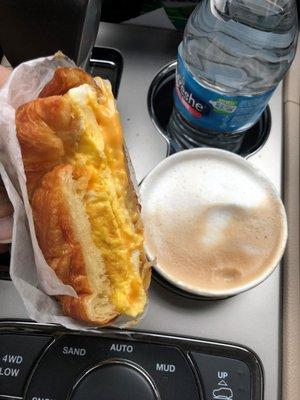 2 eggs & cheese croissant sandwich and a latte.