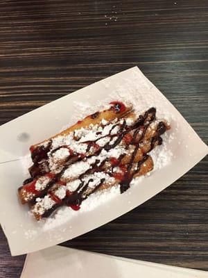 Funnel Cake sticks with sugar and chocolate raspberry drizzle