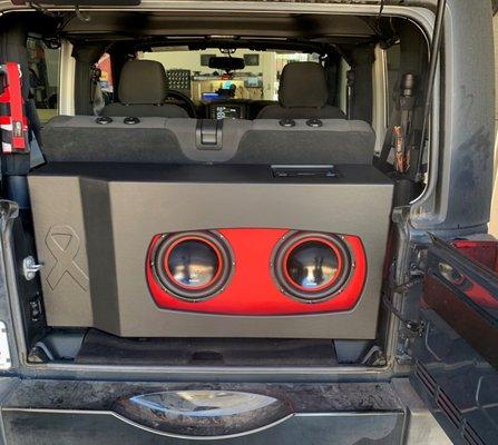 Custom Jeep box with cancer logo. Custom lighting when doors open up, hidden amp rack.