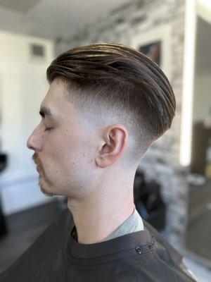 Men's Slicked-back drop fade haircut