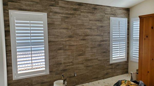 Floor tiles used as shiplap on master bedroom wall.