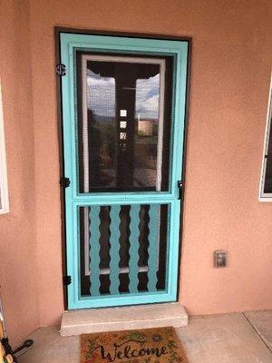 Painted scren door with wavy ballusters.