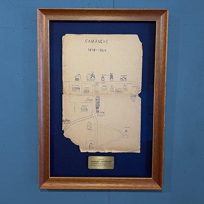 A historic map float mounted on a dark blue mat and framed with scooped moulding.