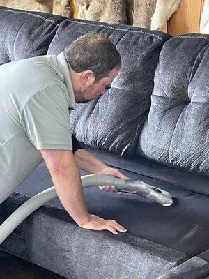 Owner, Doug, cleaning a sectional using our truck mount hot water extraction system.  The upholstery was cleaned, sanitized & deodorized