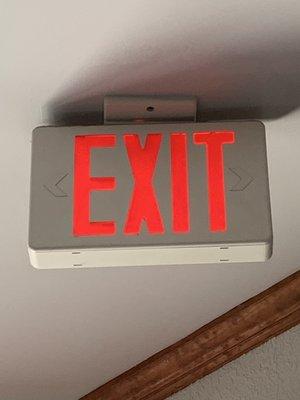 Earthbound trading company red exit sign