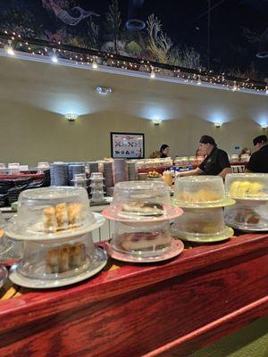 Conveyor with ample choices for both sushi lovers and those wanting tempura or gyozas.