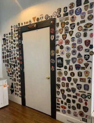 A wall of unit patches.