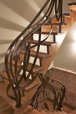 Artistic steel railing with brown patina.