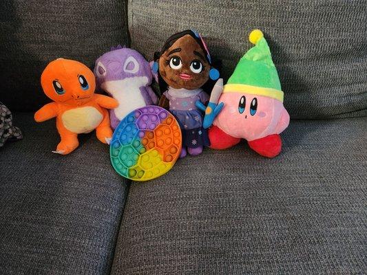 I won the Charmander, Stitch, and Kirby. The little girl and the pop it were free gifts