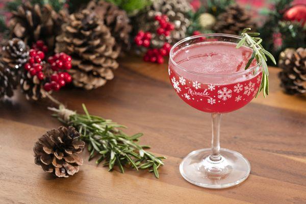 The Christmapolitan: Vodka, elderflower, dry vermouth, spiced cranberry sauce, rosemary, lime, absinthe mist