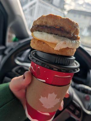 Sausage egg and cheese on a biscuit and coffee