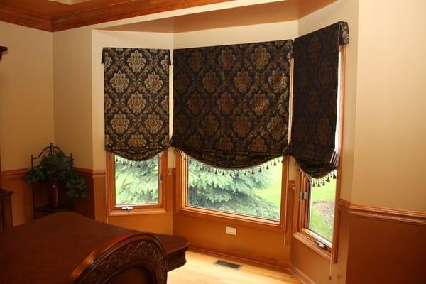 Roman shades in bay window