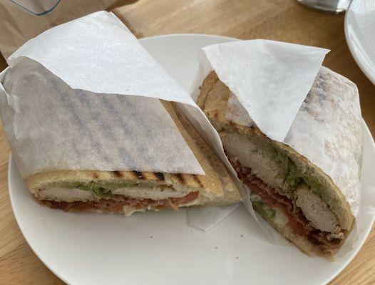 Chicken pesto panini with added bacon and tomato.