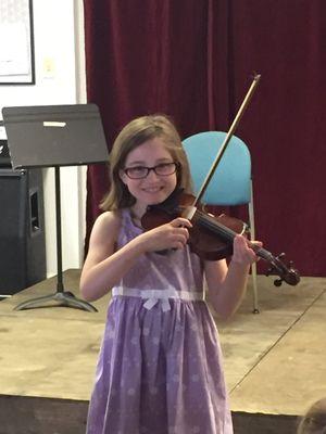 Student playing violin at one of our recitals