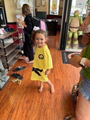 McKinley modeling one of the many custom karate shirts -- this one, earned from yellow belt.